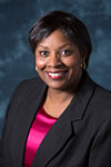 woman smiling with pink shirt and black jacket