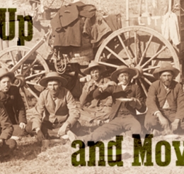 black and white photo of men by cart