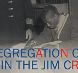 black and white photo of uniformed man at table