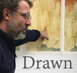 man points at artwork