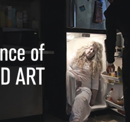man in suit opens refrigerator with woman inside