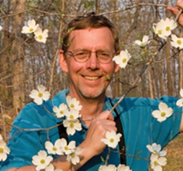 man with blooming tree branch