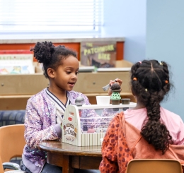 two girls playing at a table