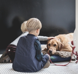 Two children with dog laying down