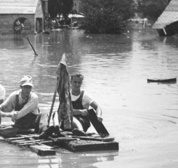 Three men on a raft in Armourdale during the 1951 Kansas City Flood.