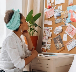 woman looks at vision board