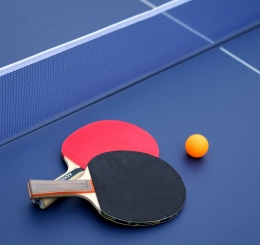ping pong paddles and ball on table