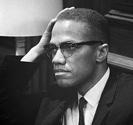 black and white photo of man with hand on head