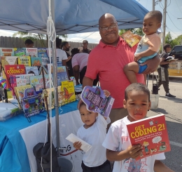 family picking out books at park