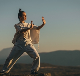 woman on mountain in tai chi pose