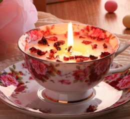 candle in teacup on plate