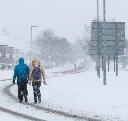 Two people walking on a snowy day