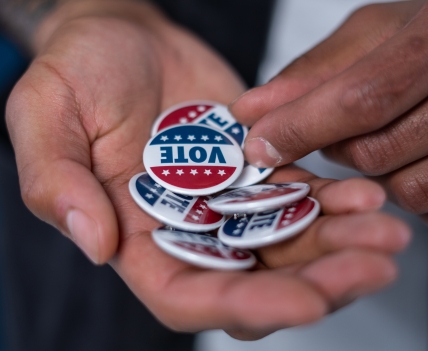 Hand filled with "vote" buttons