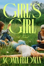 Three girls sit or lay in a daisy field