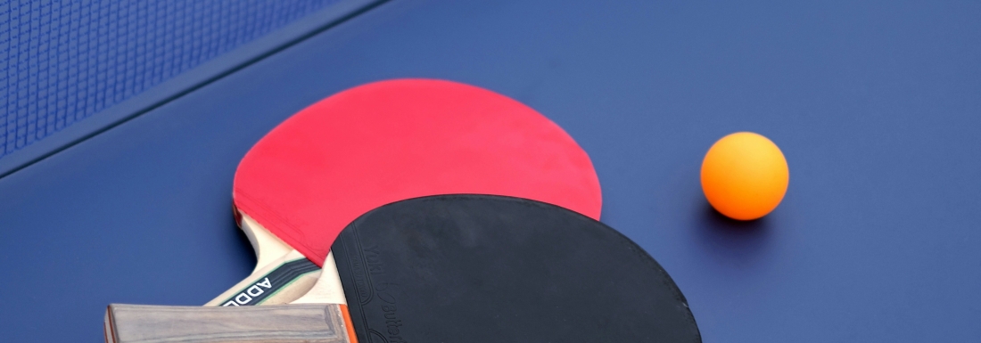 ping pong paddles and ball on table