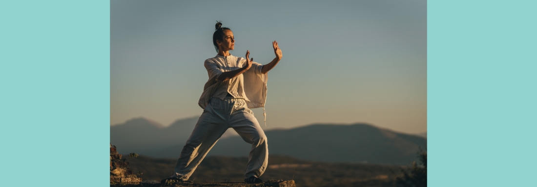 woman on mountain in tai chi pose
