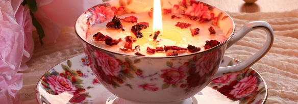 candle in teacup on plate