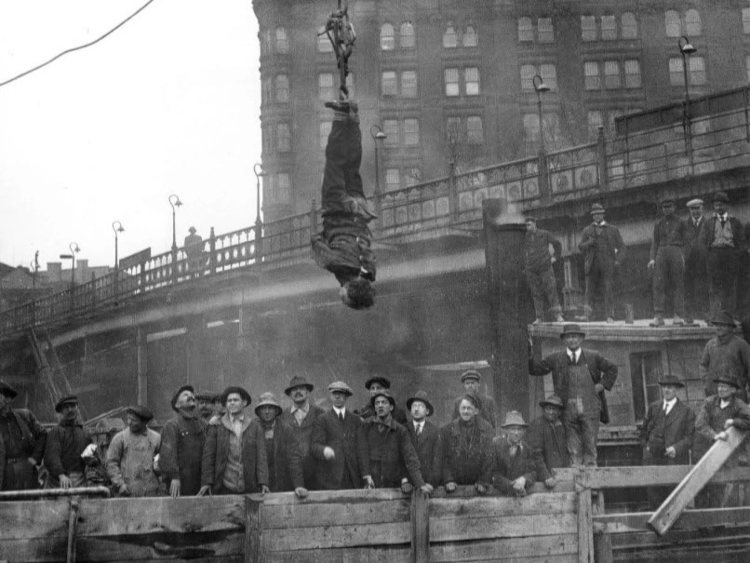 In 1916, magician Harry Houdini performed his famous escape while suspended upside down in a straitjacket over an open subway excavation in New York City. Houdini debuted the stunt in September 1915, at the corner of 10th and Main streets in downtown Kansas City, Missouri.