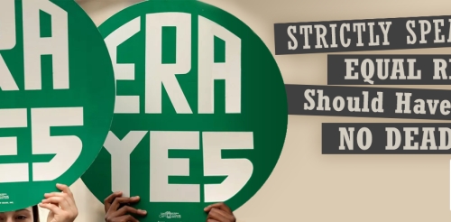 two people hold up circular signs