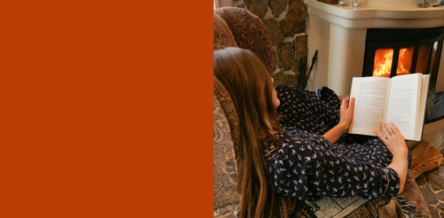 woman reading by fire