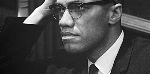 black and white photo of man with hand on head